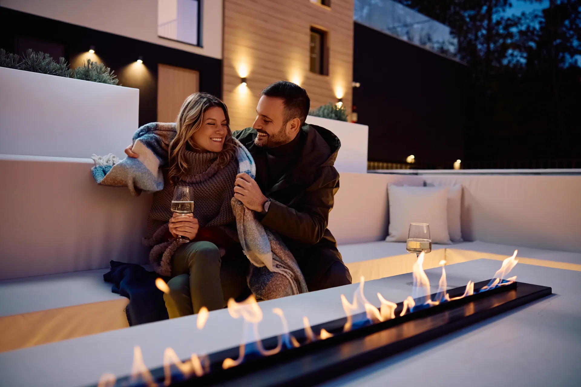 Couple by a fire pit at twilight in the Pacific Northwest