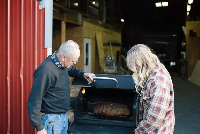 Ryann and her father Bob grilling together at Chimney Techniques